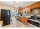 Efficient kitchen with stainless steel appliances and tile backsplash at 2410 E Palifox St, Tampa, FL 33610