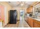 Functional kitchen with wood cabinets, double sink, and tile backsplash at 2410 E Palifox St, Tampa, FL 33610