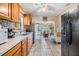 Traditional kitchen layout with wood cabinets and tiled backsplash at 2410 E Palifox St, Tampa, FL 33610