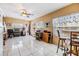 Spacious living room featuring tile flooring, large windows, and ceiling fan at 2410 E Palifox St, Tampa, FL 33610