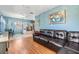 Spacious living room with comfortable leather seating, display cabinets, and large windows at 2410 E Palifox St, Tampa, FL 33610