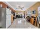 Open-concept living space with tile floors, ceiling fan, and ample natural light at 2410 E Palifox St, Tampa, FL 33610