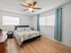 Bright bedroom with wood floors, neutral walls, and ample natural light from the window at 2523 Blackwood Cir, Clearwater, FL 33763