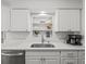 Close up view of a kitchen showcasing a stainless steel sink, quartz countertop, and built-in shelves at 2523 Blackwood Cir, Clearwater, FL 33763