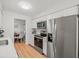 Well-lit kitchen with stainless steel appliances, white cabinets, and view to the dining area at 2523 Blackwood Cir, Clearwater, FL 33763