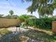 Backyard patio with grill, chairs, and garden at 2523 Blackwood Cir, Clearwater, FL 33763