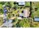 Aerial view of a home with mature trees and a circular driveway at 2903 Oak Crest Dr, Plant City, FL 33565