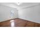 Simple bedroom with hardwood floors, a window and white walls at 2903 Oak Crest Dr, Plant City, FL 33565