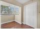 Bright bedroom with hardwood floors, natural light from a window, and a large closet at 2903 Oak Crest Dr, Plant City, FL 33565