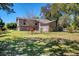 Charming front yard with lush green lawn and mature trees, creating a serene setting at 2903 Oak Crest Dr, Plant City, FL 33565