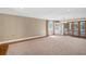Spacious living room with crown molding, large windows and carpeted flooring, perfect for relaxation and entertainment at 2903 Oak Crest Dr, Plant City, FL 33565