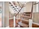 Carpeted staircase with wooden handrail and white balusters offers a blend of elegance and functionality at 2903 Oak Crest Dr, Plant City, FL 33565