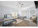 Bright bedroom featuring two beds, a ceiling fan, and a window for natural light at 311 Poinsettia Rd, Anna Maria, FL 34216