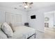 Inviting bedroom with light walls, a ceiling fan, and a mounted TV for entertainment at 311 Poinsettia Rd, Anna Maria, FL 34216