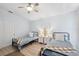 Inviting bedroom featuring two beds, bedside tables and a ceiling fan at 311 Poinsettia Rd, Anna Maria, FL 34216