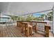 Spacious covered deck featuring wooden railings and outdoor seating with a serene view at 311 Poinsettia Rd, Anna Maria, FL 34216