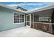 Charming turquoise house with a screened porch and ample outdoor space at 311 Poinsettia Rd, Anna Maria, FL 34216