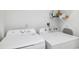 Well-equipped laundry area with both a washer and dryer for convenience at 311 Poinsettia Rd, Anna Maria, FL 34216