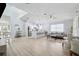 Open-concept living space featuring stylish furnishings, light wood floors, and a modern kitchen with a quartz breakfast bar at 311 Poinsettia Rd, Anna Maria, FL 34216