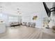 Bright living room with modern furniture, stylish decor, large windows, ceiling fan and white oak laminate flooring at 311 Poinsettia Rd, Anna Maria, FL 34216