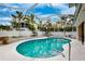 Screened-in pool area offers a private outdoor oasis surrounded by lush landscaping and sunny skies at 311 Poinsettia Rd, Anna Maria, FL 34216
