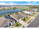 Aerial view of a home with a large backyard, pond access, and a well-kept lawn at 31879 Treasure Dock Isle, Wesley Chapel, FL 33545