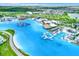 Aerial view of community lagoon featuring sandy beach areas, waterpark, restaurants, and sun loungers at 31879 Treasure Dock Isle, Wesley Chapel, FL 33545