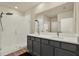 Bright bathroom featuring double sinks, wood-look flooring, and a glass enclosed walk-in shower at 31879 Treasure Dock Isle, Wesley Chapel, FL 33545