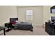 Bedroom featuring a dark colored bed with a gray comforter, a dresser, and a window at 31879 Treasure Dock Isle, Wesley Chapel, FL 33545