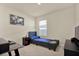 Comfortable bedroom featuring a dark-colored twin bed with a blue cushion at 31879 Treasure Dock Isle, Wesley Chapel, FL 33545