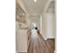 Inviting hallway with wood-look flooring and a decorative bowl on a hall table at 31879 Treasure Dock Isle, Wesley Chapel, FL 33545