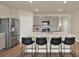 Modern kitchen with stainless steel appliances, sleek gray cabinets, and a spacious quartz countertop island at 31879 Treasure Dock Isle, Wesley Chapel, FL 33545