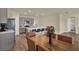 Eat-in kitchen with gray cabinetry, stainless appliances, island seating, and adjacent dining area at 31879 Treasure Dock Isle, Wesley Chapel, FL 33545
