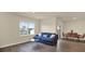 Inviting living room with modern decor, a comfortable sofa, and abundant natural light from large windows at 31879 Treasure Dock Isle, Wesley Chapel, FL 33545