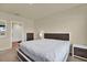 Relax in this main bedroom with modern dark wood accents and a serene, neutral color palette at 31879 Treasure Dock Isle, Wesley Chapel, FL 33545