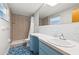 Cozy bathroom with decorative blue and white tile, a vanity sink, and a shower with tile surround at 360 22Nd Ne Ave, St Petersburg, FL 33704