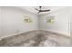 Bright bedroom featuring a ceiling fan, natural light from the windows, and a concrete floor at 360 22Nd Ne Ave, St Petersburg, FL 33704