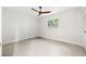 Well-lit room with a ceiling fan and a window offering natural light with a concrete floor at 360 22Nd Ne Ave, St Petersburg, FL 33704