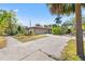 Exterior view of a cozy home with stone accents, a terracotta tile roof, and a spacious driveway at 360 22Nd Ne Ave, St Petersburg, FL 33704