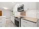 Kitchen with white cabinetry, stainless steel oven and cooktop, and granite countertops at 360 22Nd Ne Ave, St Petersburg, FL 33704