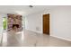 Living room with brick fireplace, a wooden door, and views of the front yard at 360 22Nd Ne Ave, St Petersburg, FL 33704