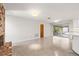 This empty living room features a red brick fireplace, light gray paint, and light colored concrete floors at 360 22Nd Ne Ave, St Petersburg, FL 33704