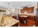 Modern kitchen featuring stainless steel appliances, granite countertops, and wood cabinetry at 3601 W Lykes Ave, Tampa, FL 33609