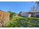 Expansive backyard featuring a green lawn, wood fence, and patio, perfect for outdoor relaxation at 3911 W Wallace Ave, Tampa, FL 33611