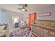 Well-lit Bedroom with crib, chair, changing table, and wood flooring at 3911 W Wallace Ave, Tampa, FL 33611