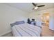 Bedroom with queen-sized bed, ceiling fan, desk and access to another room at 3911 W Wallace Ave, Tampa, FL 33611