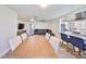 View of open concept living room and kitchen with gray sofa and breakfast bar at 3911 W Wallace Ave, Tampa, FL 33611