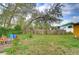 Spacious backyard featuring a wooden fence and mature trees at 40111 Pretty Redbird Rd, Zephyrhills, FL 33540