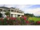 Elegant clubhouse with large columns and landscaped gardens featuring flowers at 5047 Summit View Dr, Brooksville, FL 34601