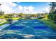 Brightly colored pickleball courts with lush landscaping and a gazebo at 5047 Summit View Dr, Brooksville, FL 34601